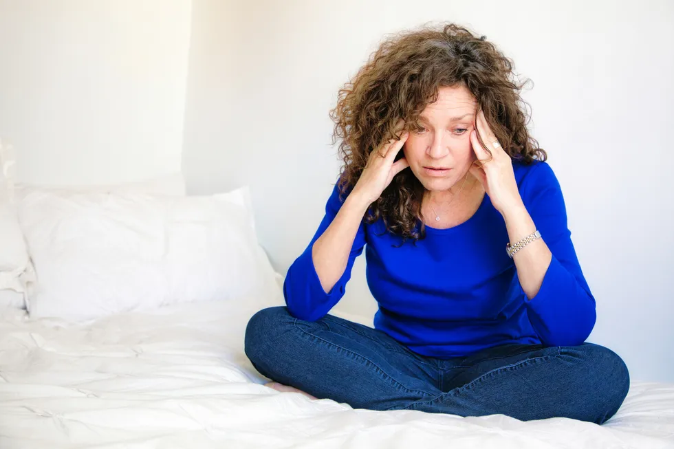 mature woman dealing with symptoms of early menopause